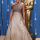 Entertainer Jennifer Lopez poses in front of an Oscar statue at the 73rd annual Academy Awards at the Shrine Auditorium in Los Angeles, California March 25, 2001. Lopez presented an award at the ceremony. REUTERS/Mike Blake BEST QUALITY AVAILABLE - GF2E47S0QVF01